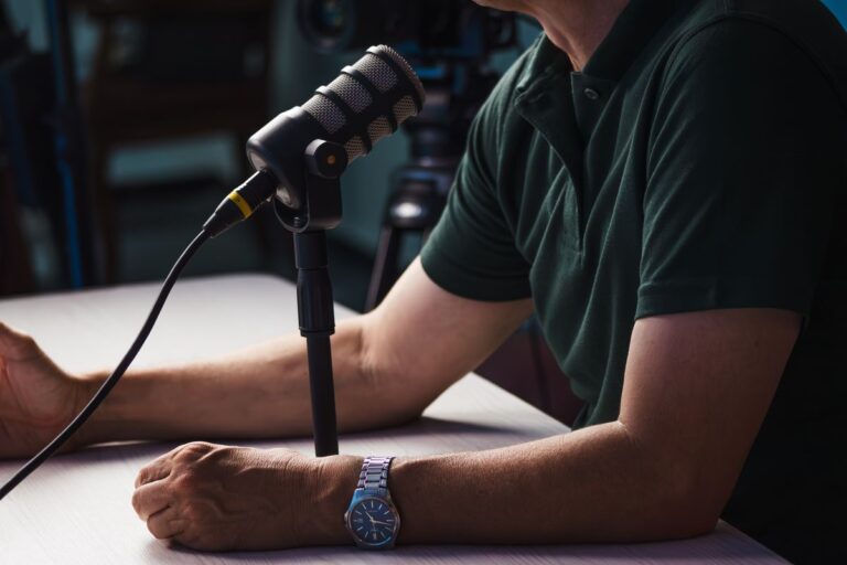 Podcast host recording with a studio microphone