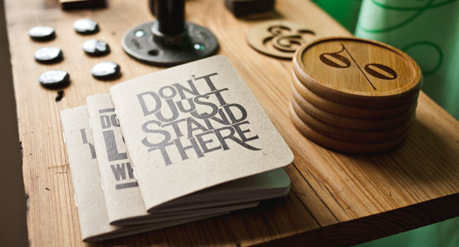 Printed notebooks and branded coasters from a creative project
