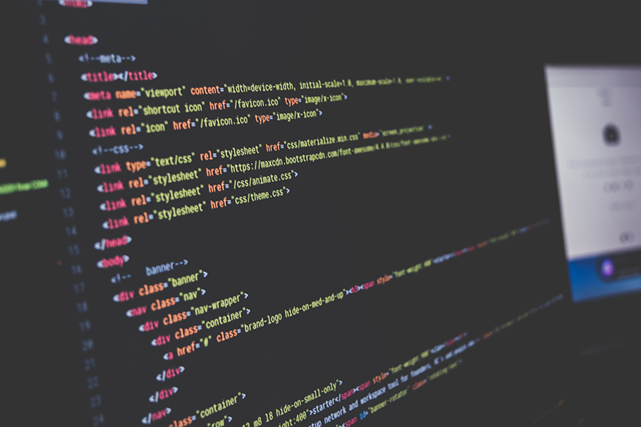 Website code open in an editor on a laptop screen